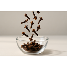Load image into Gallery viewer, Cloves falling into a glass bowl